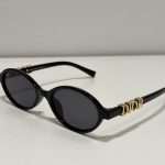 Dior oval sunglasses, elegant black design for women.