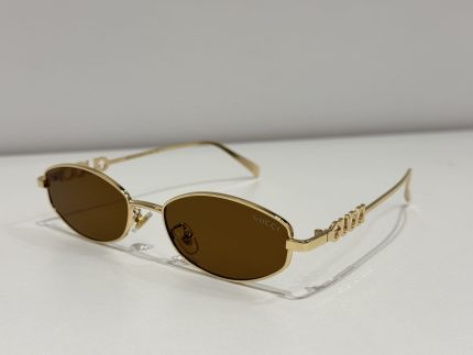 GUCCI oval sunglasses, gold frame, brown lenses, luxury eyewear.