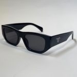 Prada women's sunglasses, elegant black design with UV protection.