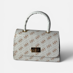 Elegant white handbag with patterned design and gold clasp.