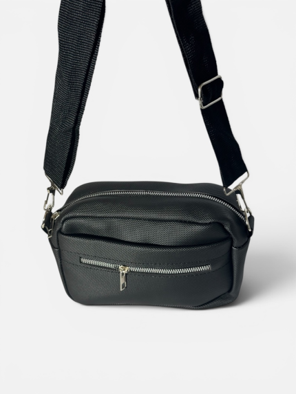 Elegant black women's bag with adjustable strap and zippers.