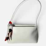 Elegant white handbag with decorative scarf for women.