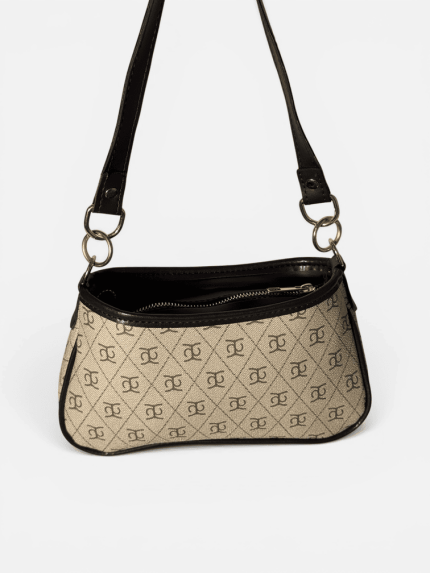 Elegant beige women's handbag with black straps and pattern.