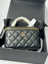 Black quilted handbag in box, elegant women's accessory.