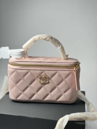 Pink quilted handbag with gold accents on display box.