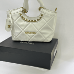 Elegant Chanel Tote Bag with quilted design and gold accents.