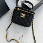 Chanel Vanity black quilted handbag with gold chain and logo.
