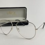 Syze Qetesuese Blue Control glasses with case, silver frame.
