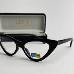 Black cat-eye glasses with blue light protection in case.