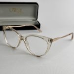 Syze Qetesuese Blue Control glasses with stylish clear frames.