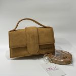 Tan Jacquemus women's handbag with strap and Daisy Store tag.