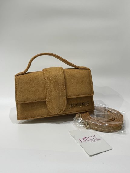 Tan Jacquemus women's handbag with strap and Daisy Store tag.