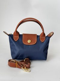 Çantë Femrash Longchamp blue handbag with brown leather accents.