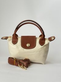Çantë Femrash Longchamp beige handbag with brown leather accents.