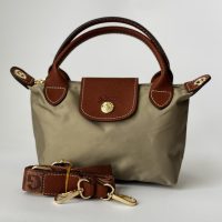 Çantë Femrash Longchamp beige handbag with brown leather accents.
