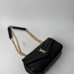 Black YSL LouLou bag with gold chain strap on display.