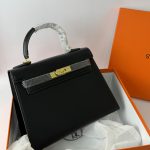 Hermes Kelly elegant black handbag in orange box for women.