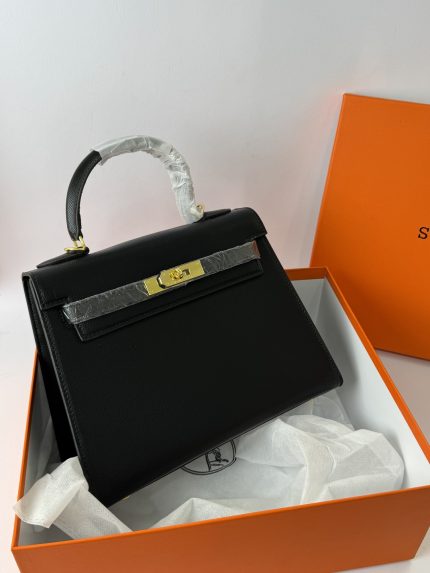Hermes Kelly elegant black handbag in orange box for women.