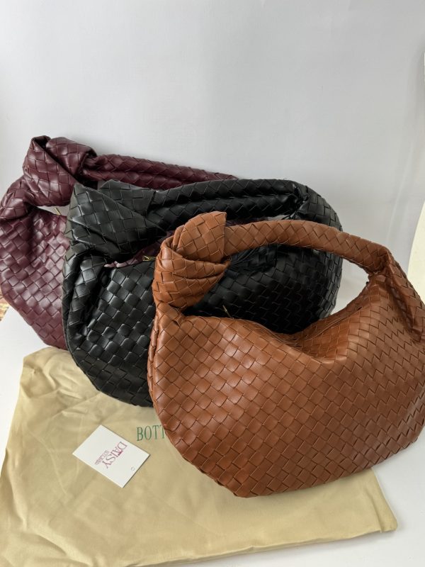 Bottega Veneta Jodie bags in brown, black, and burgundy on display.