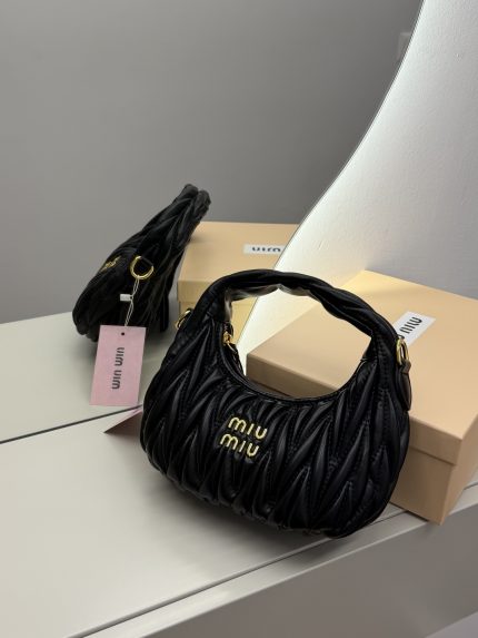 Black Miu Miu Wander Bag on display with packaging.