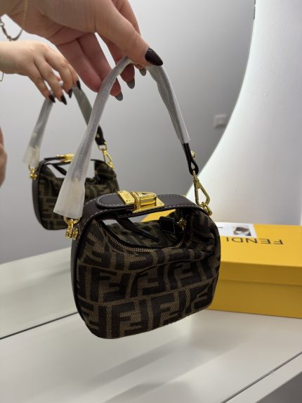Fendi Baguette Mini handbag with gold accents and logo pattern.