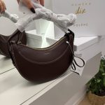 Polene Cyme Mini modern brown handbag with gold zipper detail.