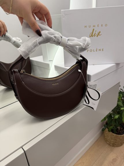 Polene Cyme Mini modern brown handbag with gold zipper detail.