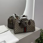 Gucci Ophidia Duffle bag with signature pattern and green-red stripe.