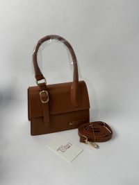 Brown YSL Le5A7 Hobo bag with detachable strap on display.
