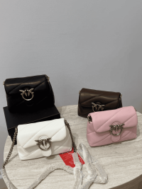 Pink Love Mini Puff handbags in pink, white, black, and brown on display.