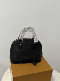 Louis Vuitton Alma Medium black handbag on box.