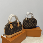 Louis Vuitton Alma Mini handbags on display boxes.