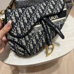 Elegant Guess women's bag with patterned design and gold accents.