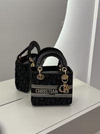 Christian Dior Elegante handbag with gold accents on display.
