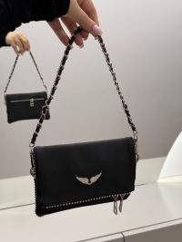 Elegant black Zadig & Voltaire handbag with chain strap and wing emblem.