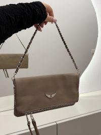Elegant Zadig & Voltaire handbag with chain strap and wing logo.