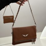 Brown leather handbag with chain strap, wing emblem, elegant design.