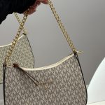 Michael Kors women's handbag with gold chain and logo pattern.