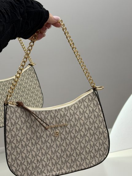 Michael Kors women's handbag with gold chain and logo pattern.