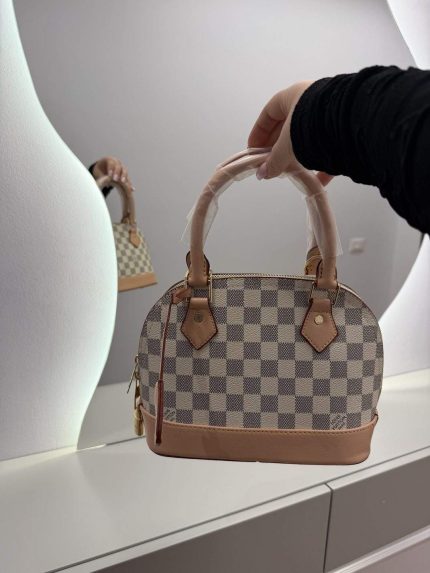 Louis Vuitton Nano Speedy handbag with checkered pattern and leather accents.