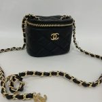 Black quilted mini Chanel bag with gold chain strap.