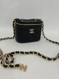 Black quilted mini Chanel bag with gold chain strap.