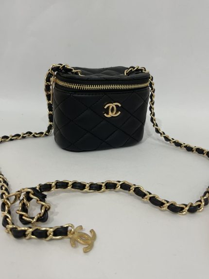Black quilted mini Chanel bag with gold chain strap.