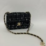 Chanel Tweed Flap Mini bag with gold chain and logo.