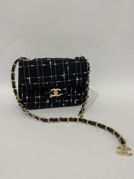 Chanel Tweed Flap Mini bag with gold chain and logo.