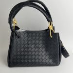 Black Bottega Veneta Intrecciato handbag with gold accents.