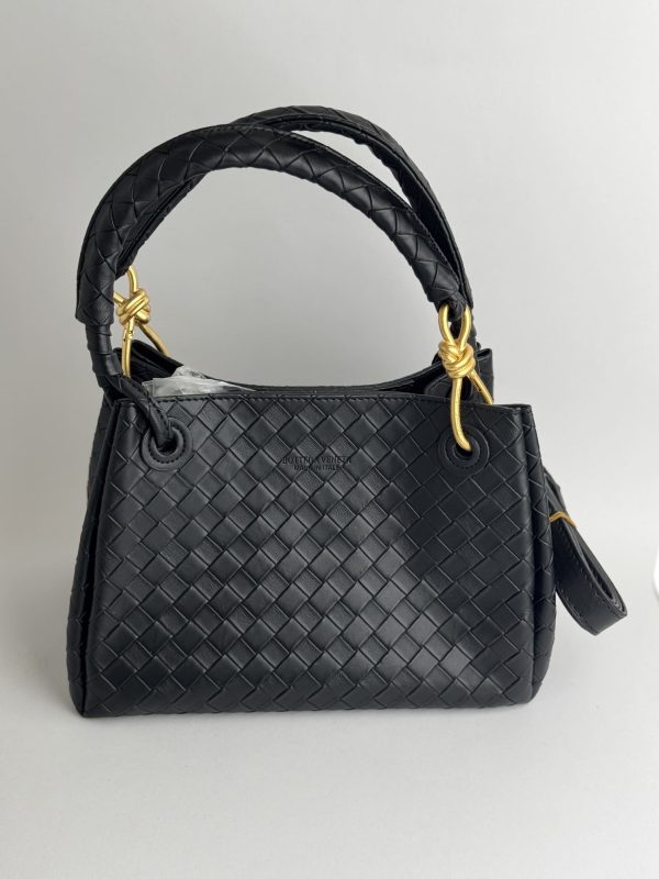 Black Bottega Veneta Intrecciato handbag with gold accents.