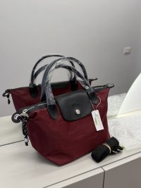 Canta Longchamp Le Pliage Cuir handbag, burgundy with black leather accents.