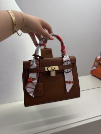 Brown Hermes Kelly Mini bag with scarf-wrapped handle.