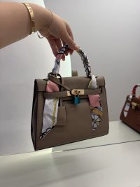 Hermes Kelly Mini handbag with colorful scarf handle detail.